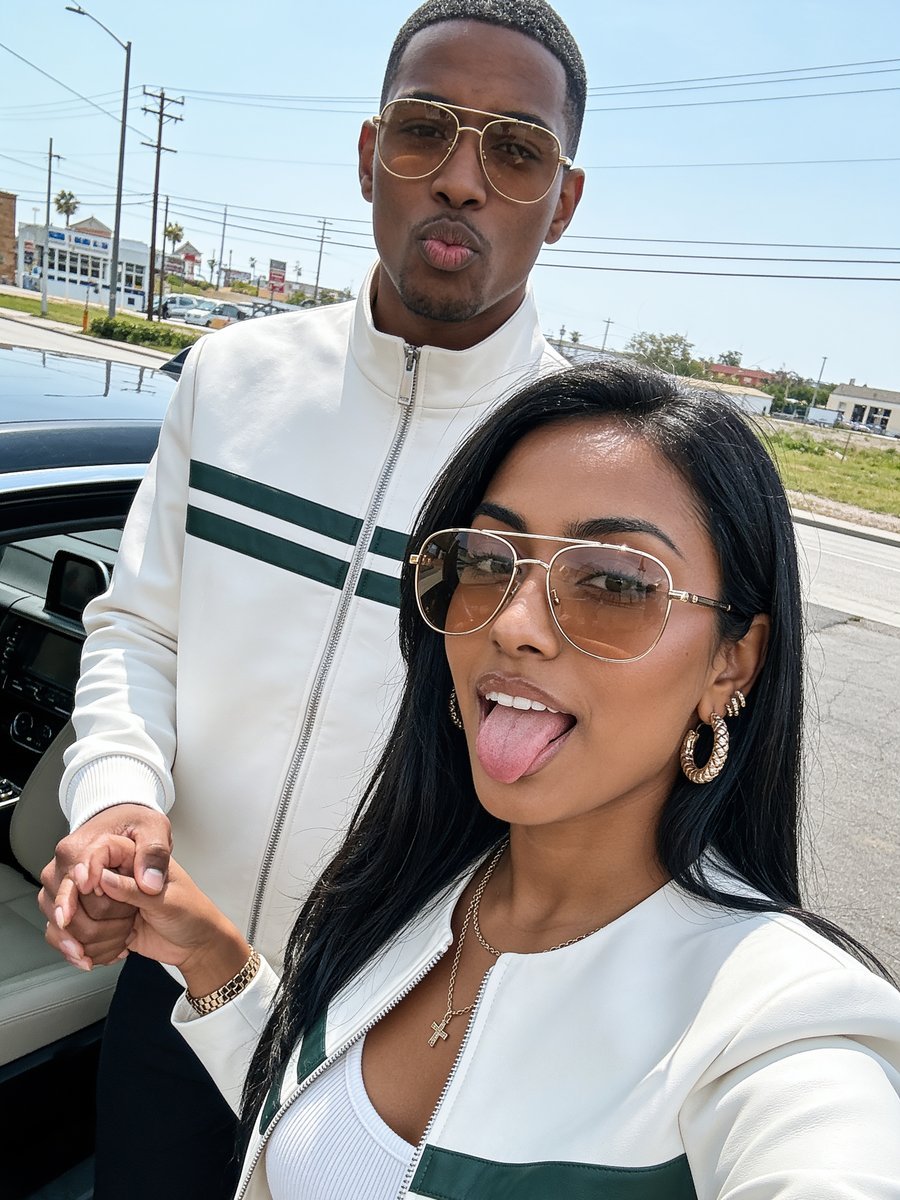 Couple posing beside their car — example of social and influencer content produced by Okuzi Real Estate